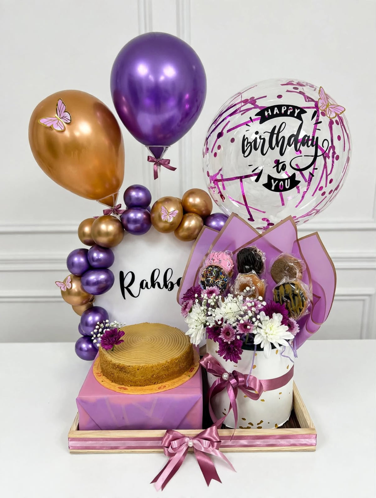 Birthday celebration gift box with cake balloons flowers and sweet treats