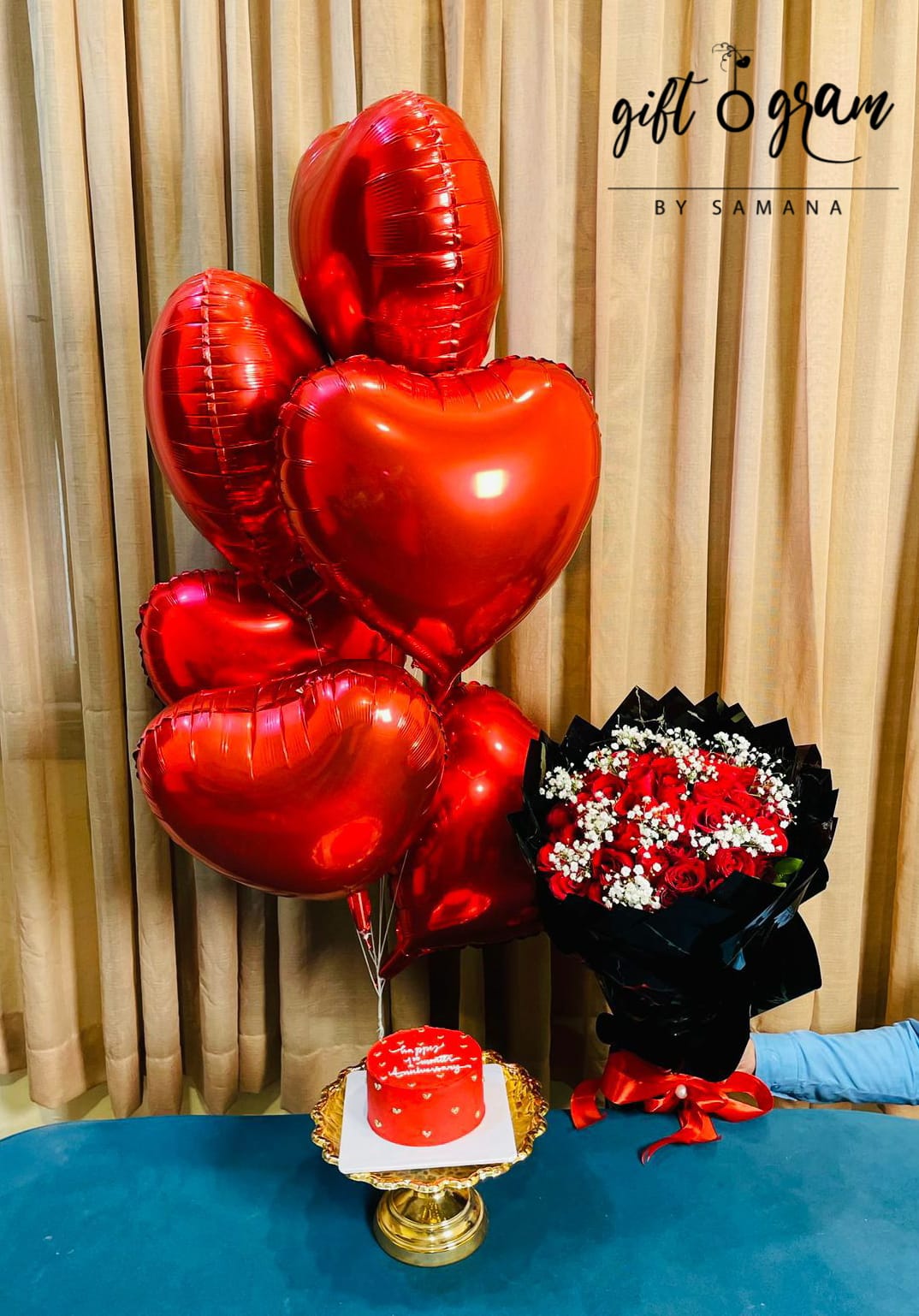 Romantic gift set with red heart balloons, roses bouquet and heart shaped cake