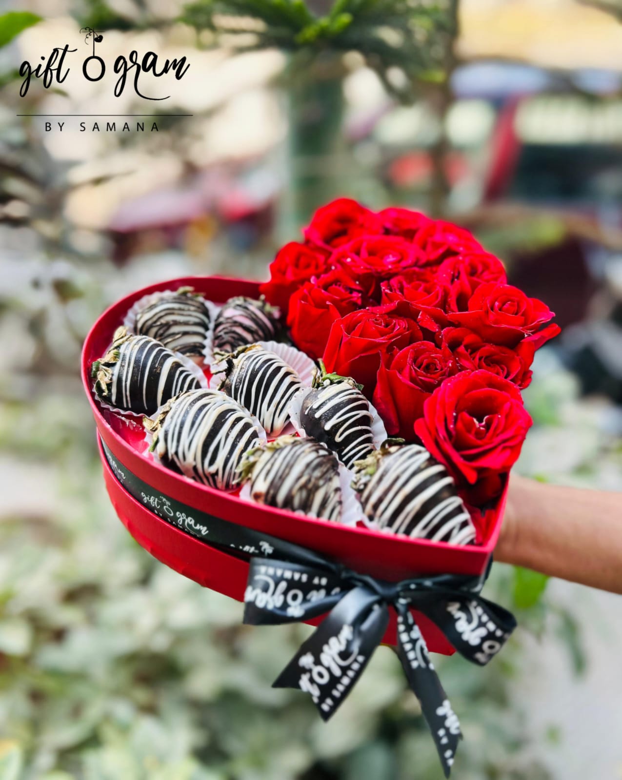 Heart shape gift box with red roses and chocolate coated strawberries