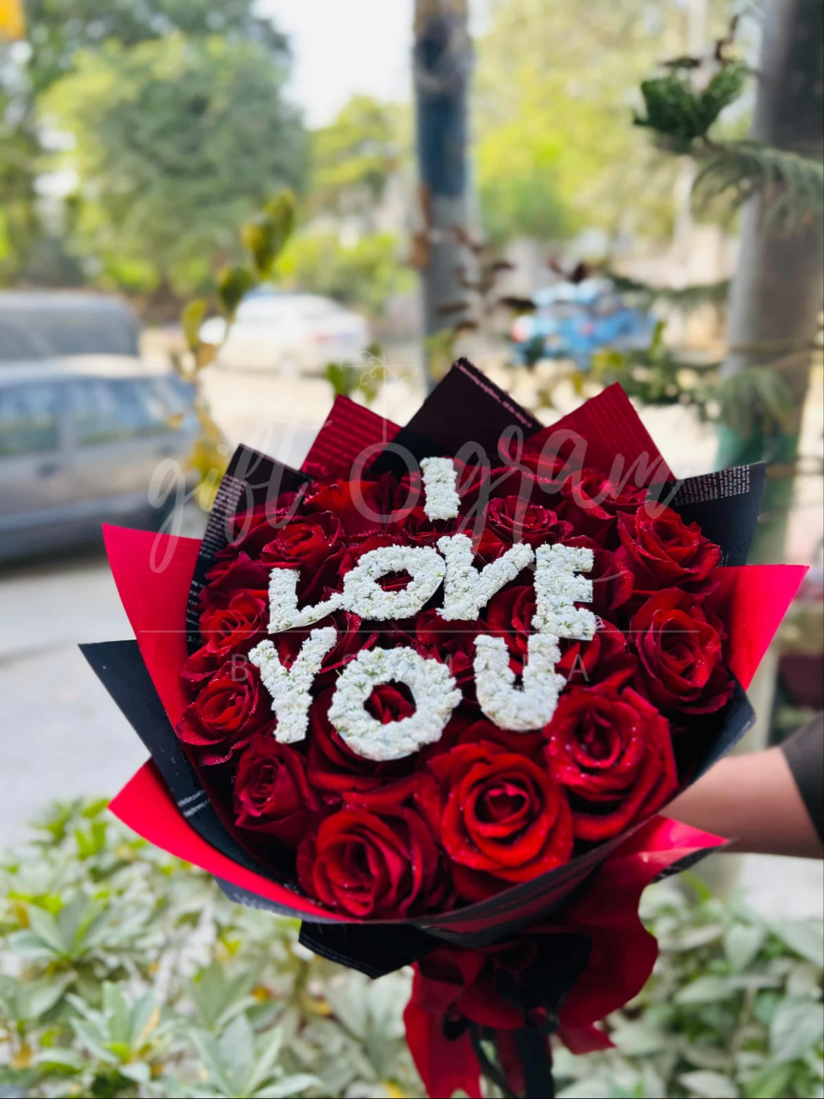 I Love You red roses bouquet with white floral lettering.
