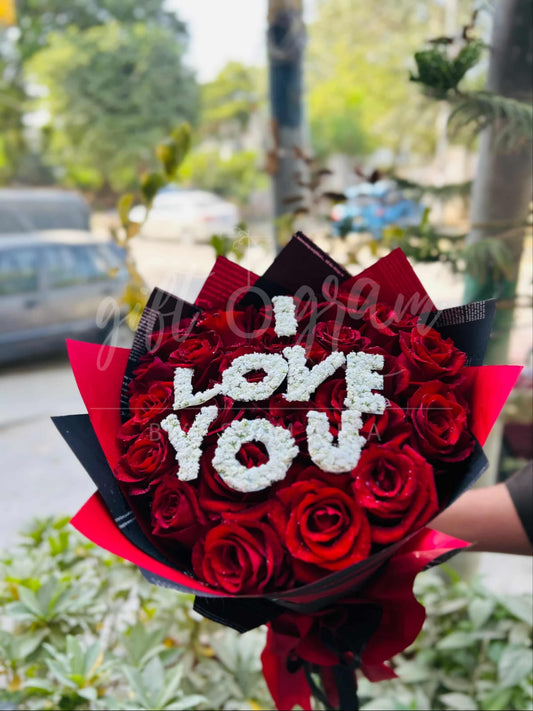 I Love You red roses bouquet with white floral lettering.