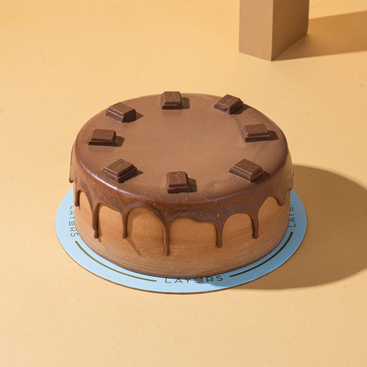 Layers Dairy Milk Chocolate Cake topped with Dairy Milk chocolate pieces available for same-day delivery in Lahore and Islamabad from Giftogram by Samana.