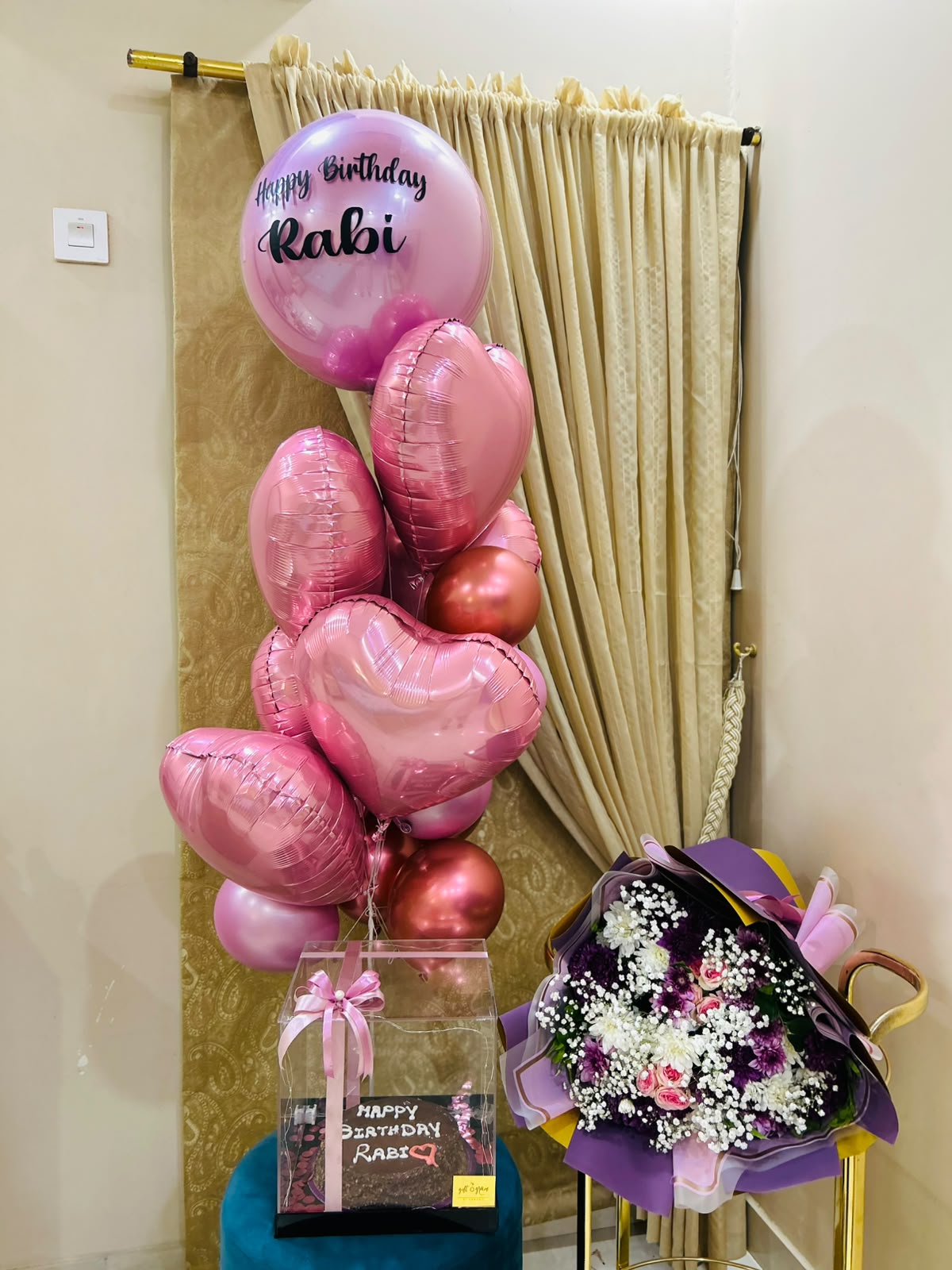 Pink birthday surprise package with balloons, personalized cake and flower bouquet