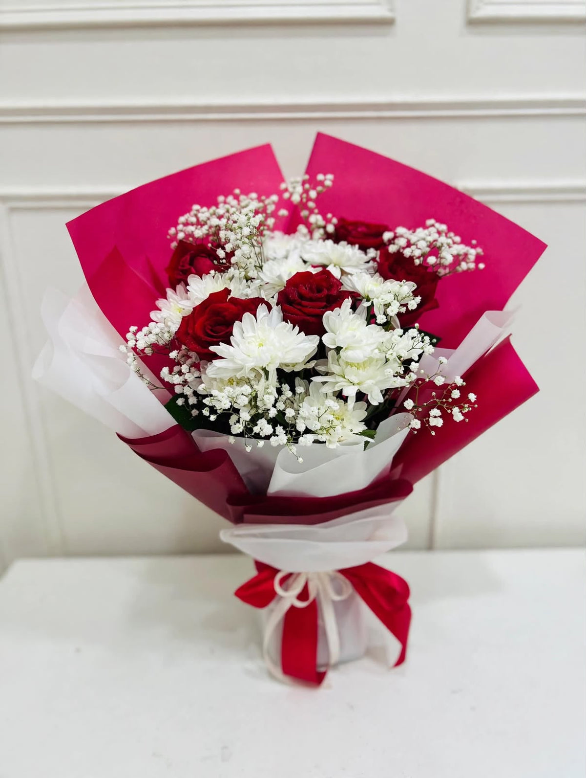 Red rose and white chrysanthemum bouquet with baby's breath