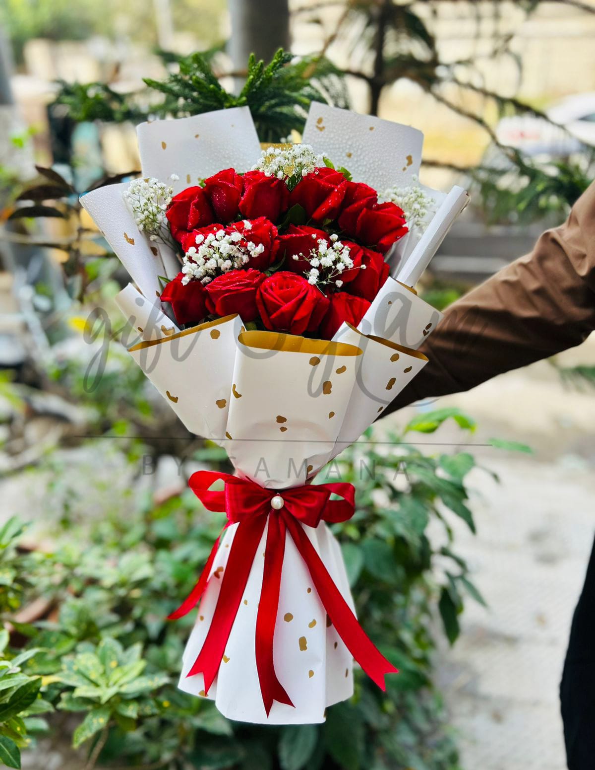 Classic red roses bouquet wrapped in white paper with red ribbon for gifting in Karachi Pakistan