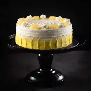 Original Delizia Royal Pineapple Cake featuring soft vanilla sponge, fresh pineapple filling, and whipped cream frosting.
