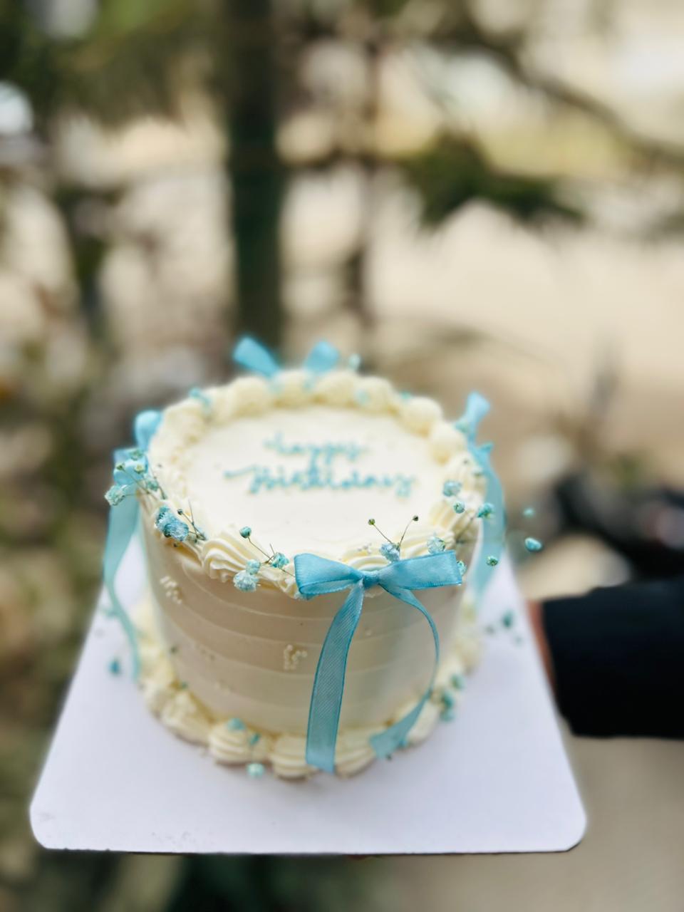 Small bento birthday cake with blue ribbon in Karachi Pakistan