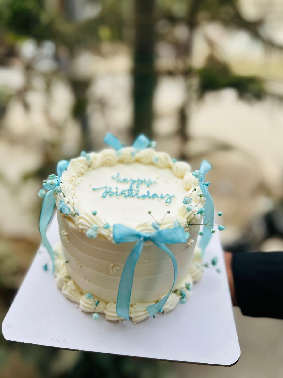 Small bento birthday cake with blue ribbon in Karachi 