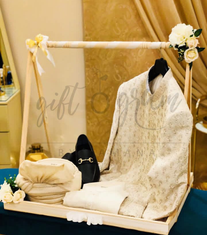 Wooden cart bridal and groom gift packaging with floral décor and dress display